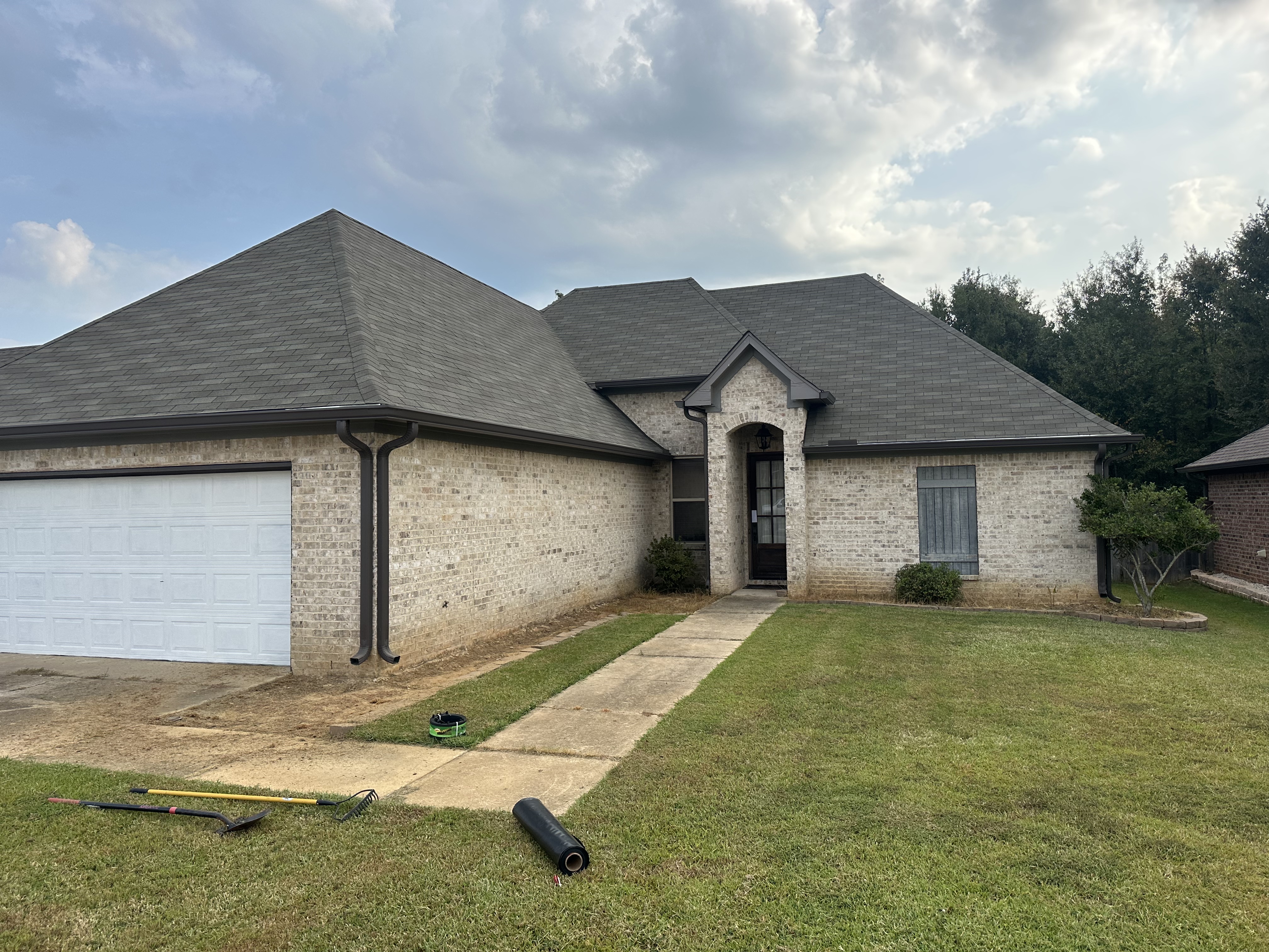 Fresh sod rolls on driveway